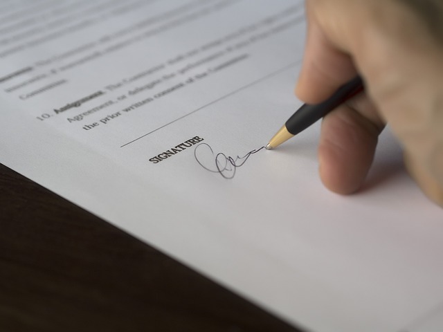 **Hand signing a lease contract document**